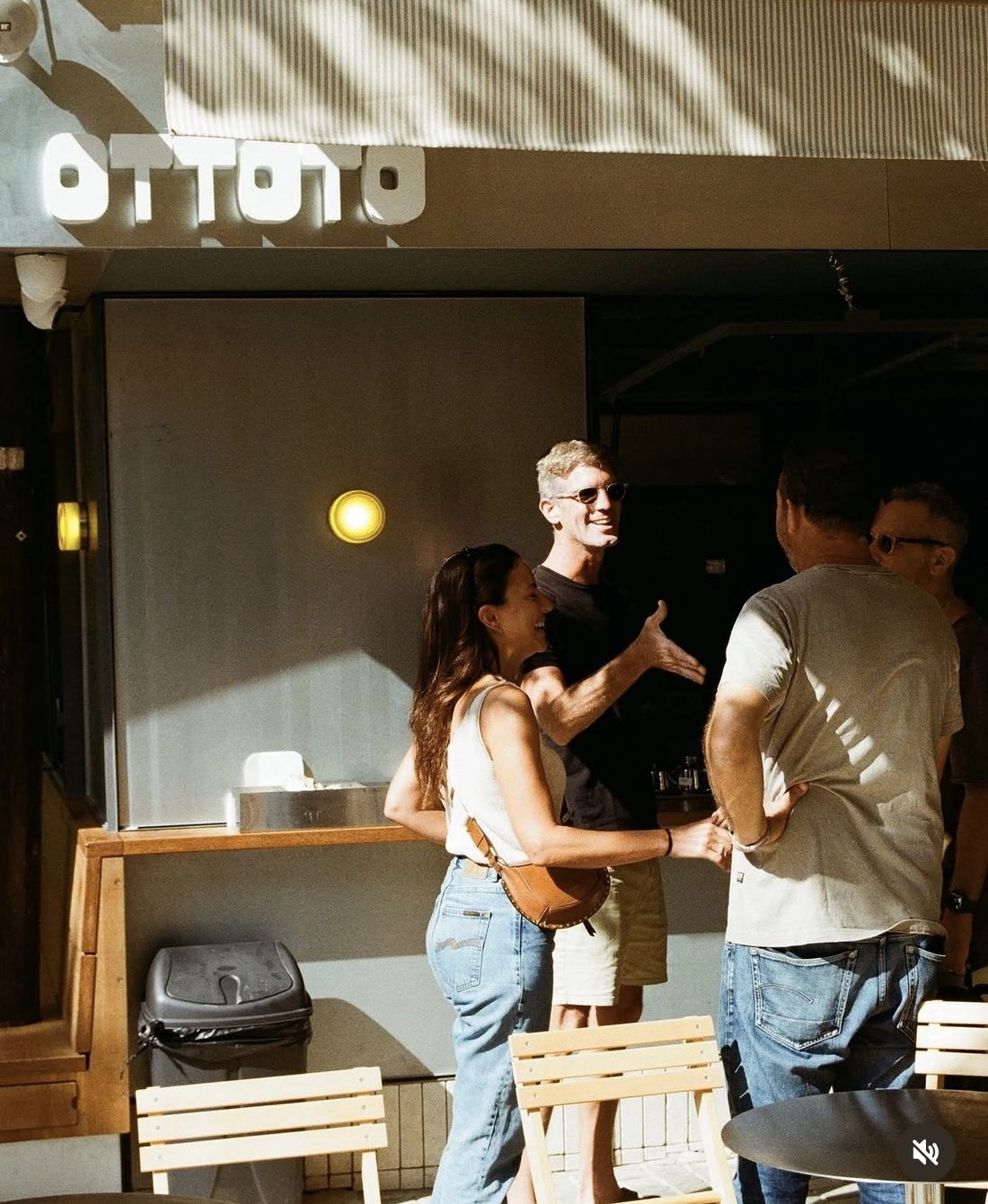 Guests talking and laughing outside the OTTOTO kiosk in the sun