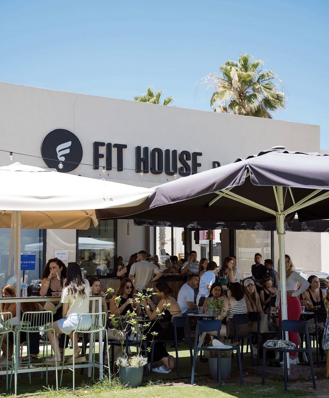 The café terrace at a FIT HOUSE branch, busy with guests