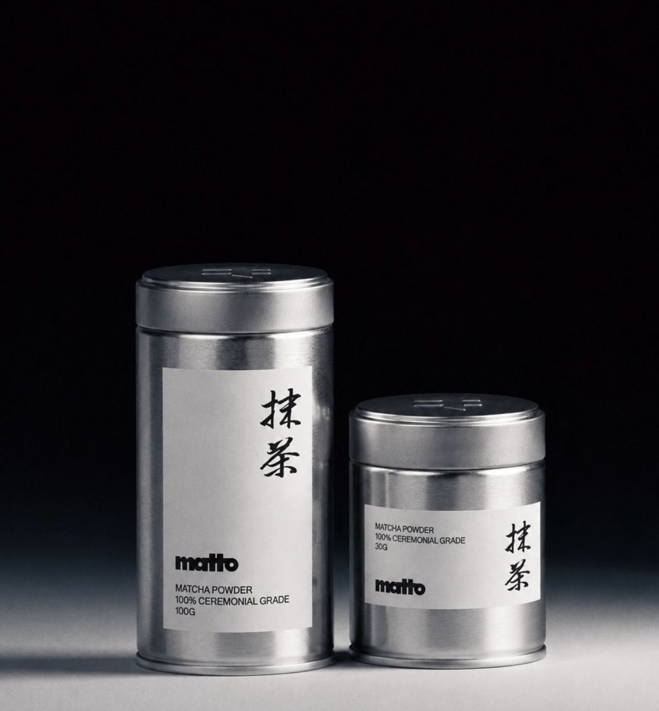 Two MATTO ceremonial-grade matcha tins on a dark studio background